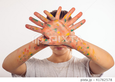 teenage girl covers her face with palms in paint teenage girl covers her face with palms in paint 41762578