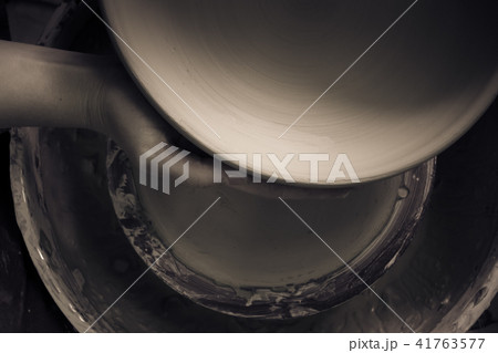 Potter holds round clay plate in his hands. Potter holds round clay plate in his hands. 41763577