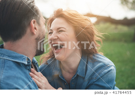 Joyful loving couple having rest on meadow  41764455