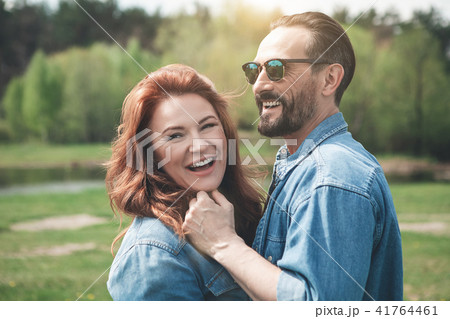 Positive middle-aged man and woman hugging outdoor  41764461