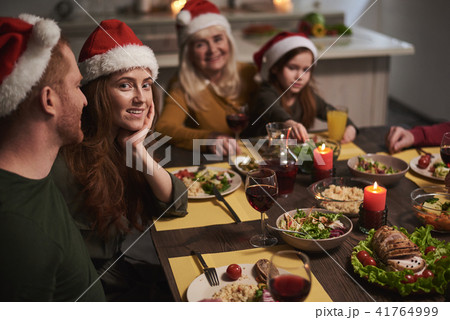 Happy woman among family on Christmas Happy woman among family on Christmas 41764999