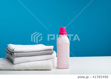 Bath towels folded near bottle of softener 41765490