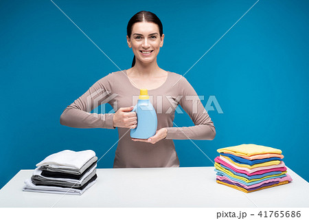 Smiling woman with laundry detergent Smiling woman with laundry detergent 41765686