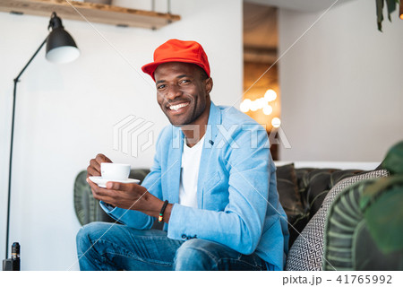Happy man tasting mug of beverage Happy man tasting mug of beverage 41765992