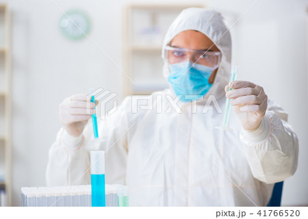 Young chemist student working in lab on chemicals 41766520