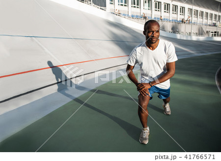 Glad athlete standing on track field Glad athlete standing on track field 41766571