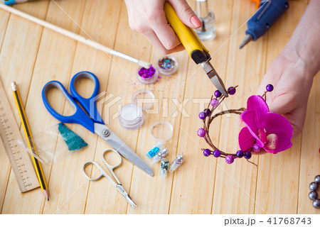 Woman making jewelry at home 41768743