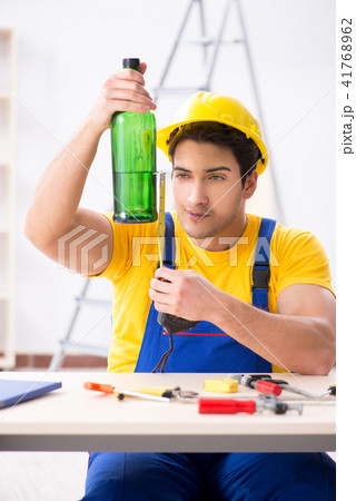 Drunk engineer working in the workshop Drunk engineer working in the workshop 41768962
