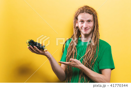 Happy man holding a bunch of grapes 41770344
