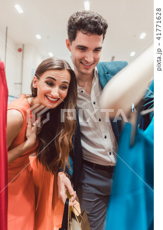 Couple checking the new arrivals in fashion boutique Couple checking the new arrivals in fashion boutique 41771628