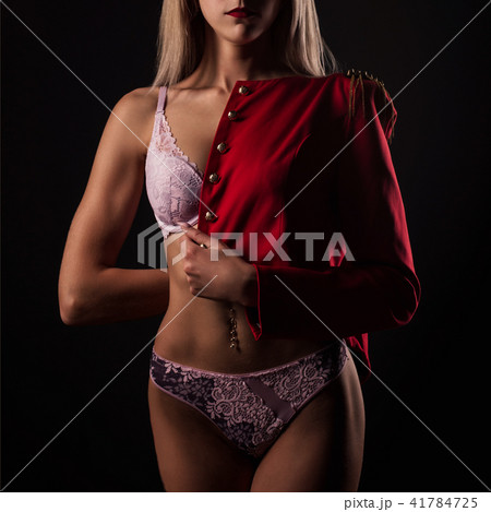 Blonde young woman in lace lingerie and red jacket Blonde young woman in lace lingerie and red jacket 41784725