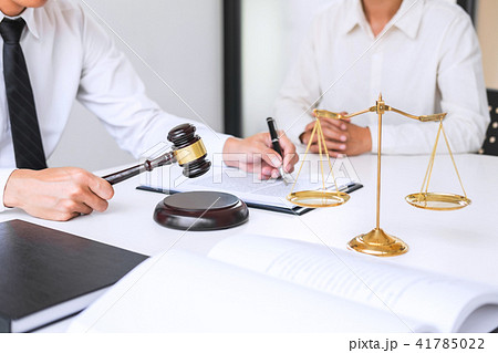 Businesspeople or lawyer having team meeting discussing agreemen Businesspeople or lawyer having team meeting discussing agreemen 41785022