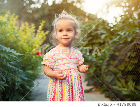 a little girl dressed in a fashionable dress a little girl dressed in a fashionable dress 41788089