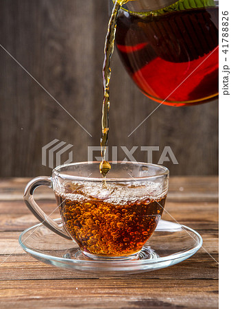 Black tea poured from teapot 41788826