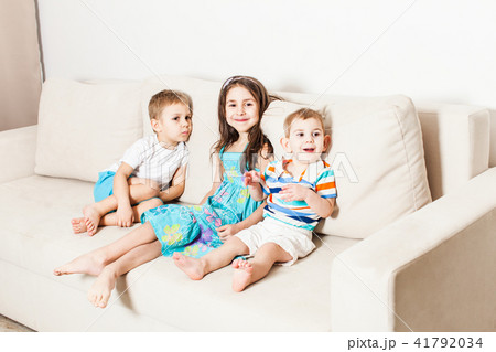 Photo of beautiful children on white modern couch. 41792034
