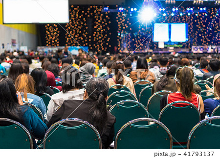 Rear view of Audience in the conference hall or seminar meeting which have Speakers on the stage, business and education about investment concept Rear view of Audience in the conference hall or seminar meeting which have Speakers on the stage, business and education about investment concept 41793137