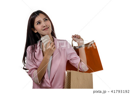 Happy young asian woman shopping in happy feeling and holding the product paper bag on white background, include clipping path 41793192
