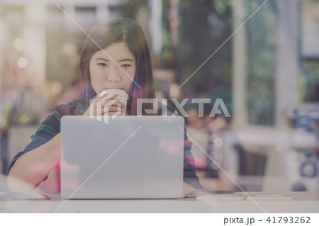 Portrait of asian businesswoman in casual suit drinking and working with technology laptop in happiness action at the desk beside the glass in modern office, Business owner and entrepreneur concept Portrait of asian businesswoman in casual suit drinking and working with technology laptop in happiness action at the desk beside the glass in modern office, Business owner and entrepreneur concept 41793262