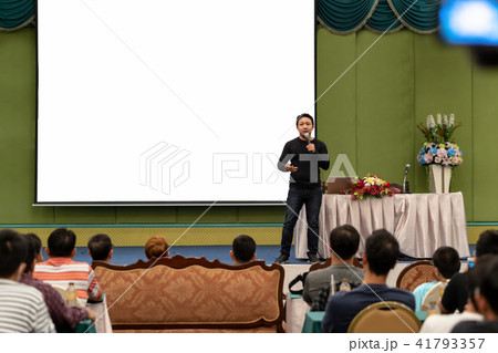 Closeup portrait of asian Speaker with casual suit on the stage over the presentation screen in the conference hall or seminar meeting, business and education concept 41793357
