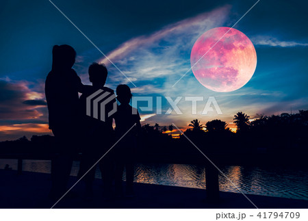 Silhouette of mother with children with red moon. Silhouette of mother with children with red moon. 41794709