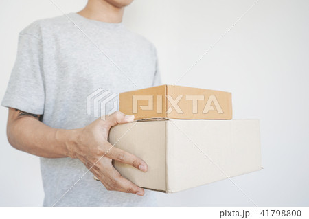 Deliveryman holding parcel boxes package 41798800
