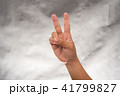 Hand holds 2 inches of finger on Gray background 41799827