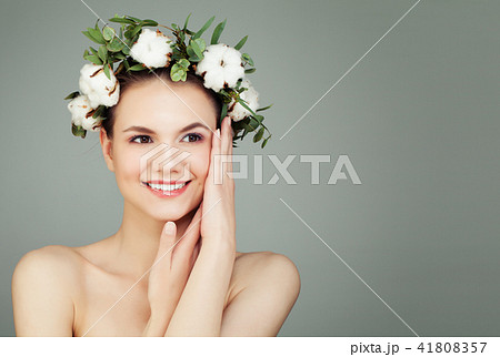 Happy young woman with cotton flowers and green leaves on banner Happy young woman with cotton flowers and green leaves on banner 41808357