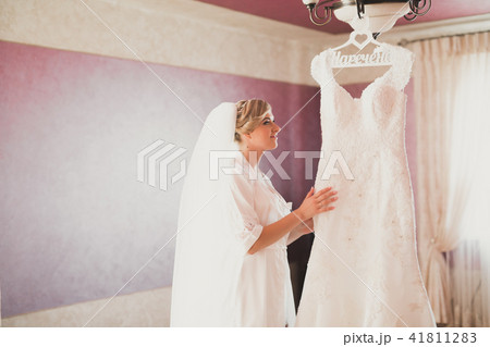 Beautiful bride wearing fashion wedding dress with feathers with luxury delight make-up and Beautiful bride wearing fashion wedding dress with feathers with luxury delight make-up and 41811283