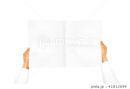 Hand in white shirt sleeve holding blank journal 41812694