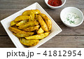 Potato wedges with souce on wooden background 41812954