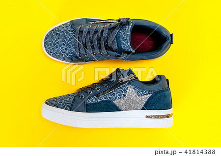 Women's sport shoes isolated on yellow background Women's sport shoes isolated on yellow background 41814388
