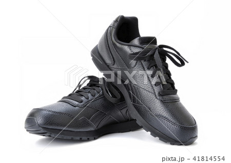 Black women's sports shoe on a white background. Black women's sports shoe on a white background. 41814554
