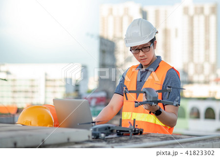 Male worker using drone and laptop for site survey 41823302