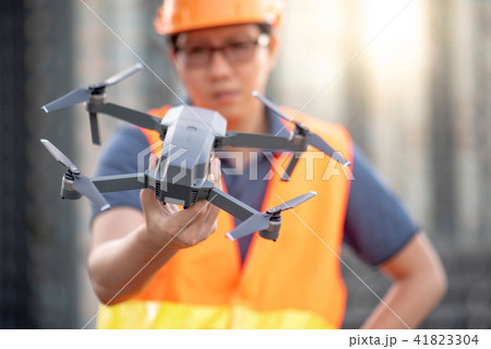 Asian engineer holding drone at construction site Asian engineer holding drone at construction site 41823304