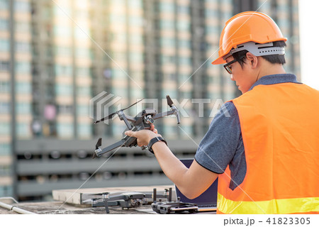 Male worker using drone and laptop for site survey Male worker using drone and laptop for site survey 41823305