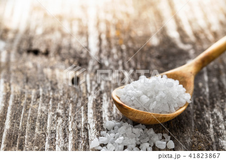 Sea salt  in a spoon on wooden table 41823867
