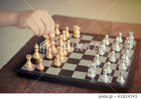 Kid hold chess pieces in chess game . Kid hold chess pieces in chess game . 41824545