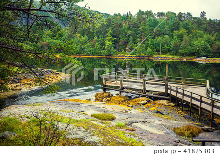 Wooden deck on a lakeshore Wooden deck on a lakeshore 41825303