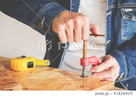 Carpenter working carefully looking at the plans work in carpent Carpenter working carefully looking at the plans work in carpent 41826920