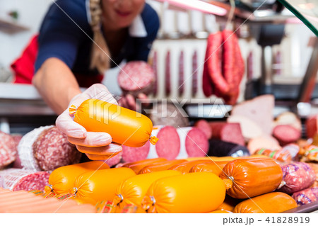 Butcher shop woman holding meat in her hand Butcher shop woman holding meat in her hand 41828919