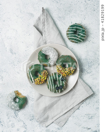 Vegan donuts topped spirulina glaze Vegan donuts topped spirulina glaze 41829199