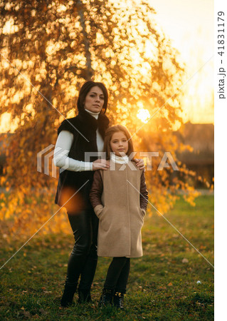 Little girl with mother walking in the park in autumn. Golden autumn 41831179