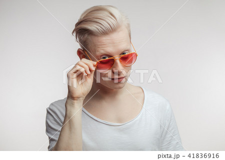 Portrait of fashion young man in pink glasses with shopping bags Portrait of fashion young man in pink glasses with shopping bags 41836916