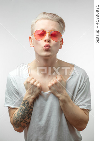 Portrait of fashion young man in pink glasses with shopping bags Portrait of fashion young man in pink glasses with shopping bags 41836931