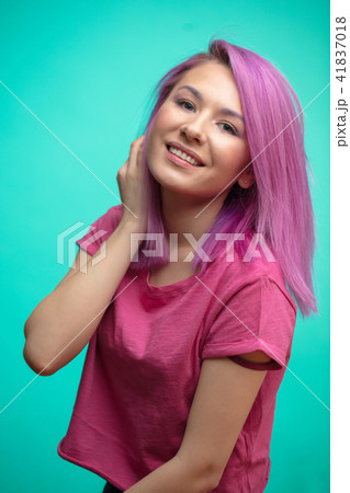 Young female model with pink hair, smiling broadly, feeling joy. 41837018