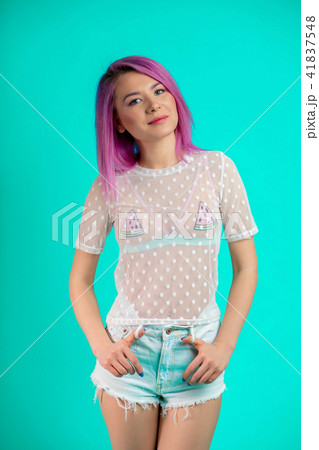 Fit woman with violet hair, dressed in transparent blouse and shorts isolated Fit woman with violet hair, dressed in transparent blouse and shorts isolated 41837548