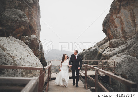 Wedding couple in love kissing and hugging near rocks on beautiful landscape 41838517