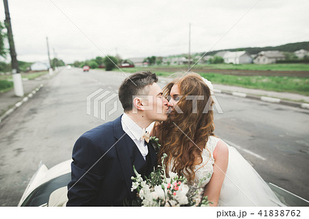 Happy bride and groom posing after wedding ceremony Happy bride and groom posing after wedding ceremony 41838762
