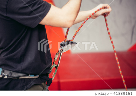 Rock climber wearing safety harness and safety rope in, close-up image Rock climber wearing safety harness and safety rope in, close-up image 41839161