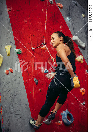 Active happy woman overhanging on tightrope in the training climbing center Active happy woman overhanging on tightrope in the training climbing center 41839229